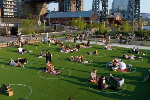 People sit in designated social distancing circles at Domino Park in Williamsburg, Brooklyn, New York on Friday, May 15, 2020. (Gardiner Anderson/for New York Daily News)