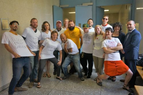 Gardeners and supporters of the Eldert Street Garden in Bushwick, Brooklyn, gathered at a Brooklyn courthouse in their garden-specific shirts and accompanied by Paula Segal, the well-known environmental justice lawyer that represented both the Eldert Street Garden and the Maple Street Community Garden in court. Photo retrieved from the Eldert Street Garden page on Living Lots NYC at https://livinglotsnyc.org/